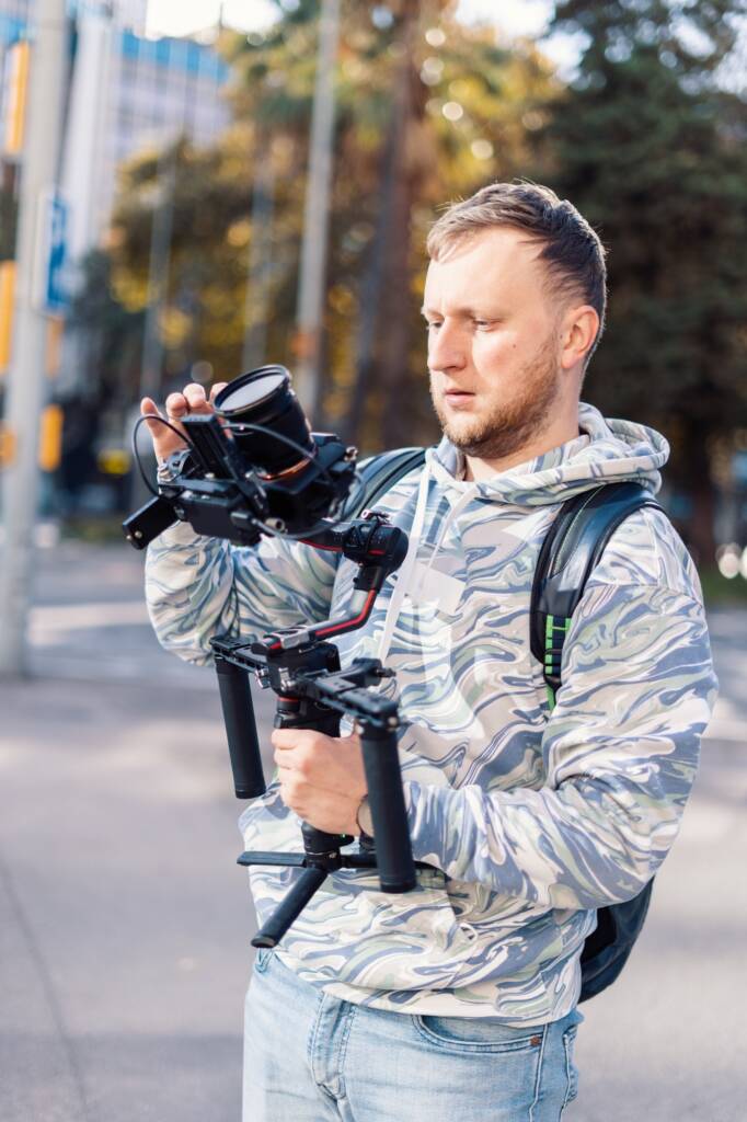 Professional videographer with gimball video setup during shooting